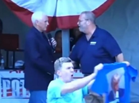 A man heckles Mike Pence with a "NEVER SURRENDER" shirt featuring Trump's mugshot in New Hampshire.